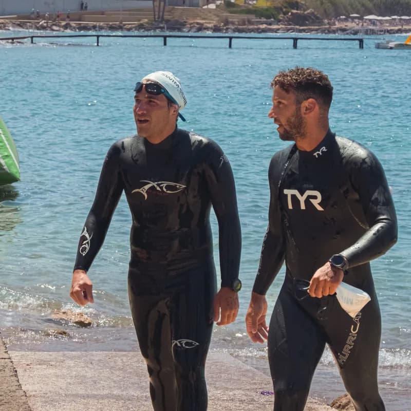 Athletes finishing at Cyprus Swim Series in wetsuits